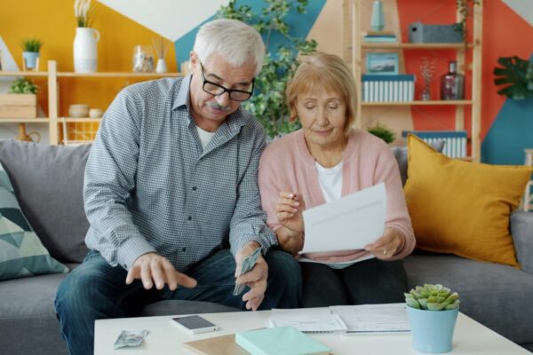 Elderly couple reviewing documents at home