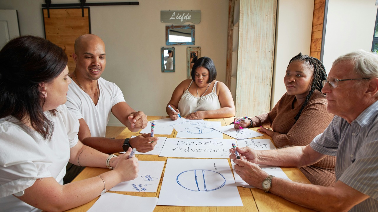 A group of people are brainstorming and sketching together