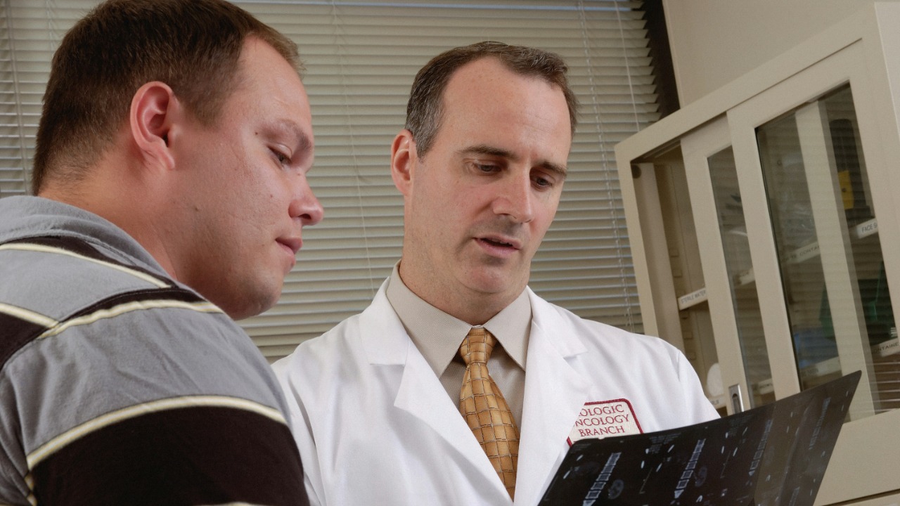 man in white dress shirt holding black tablet computer