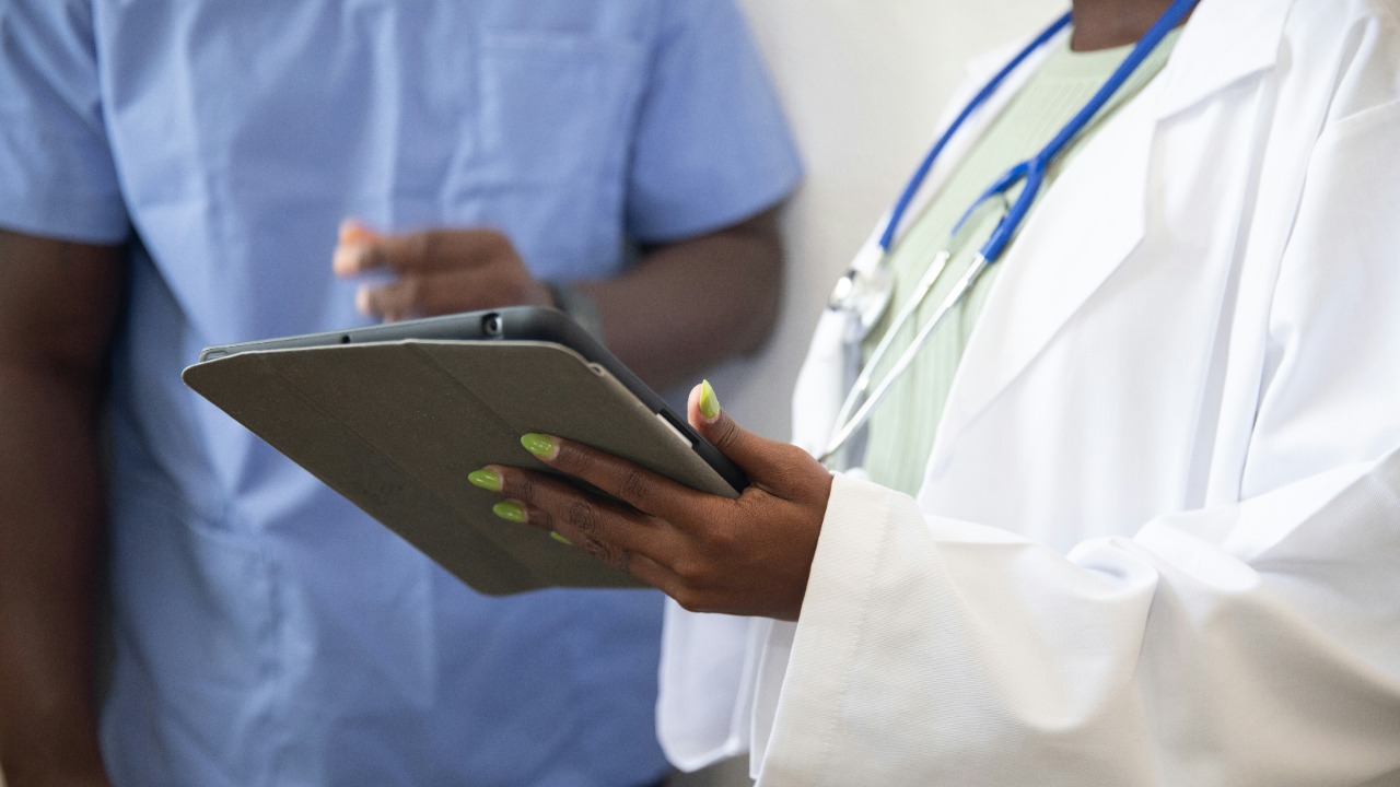 a doctor showing a patient something on the tablet