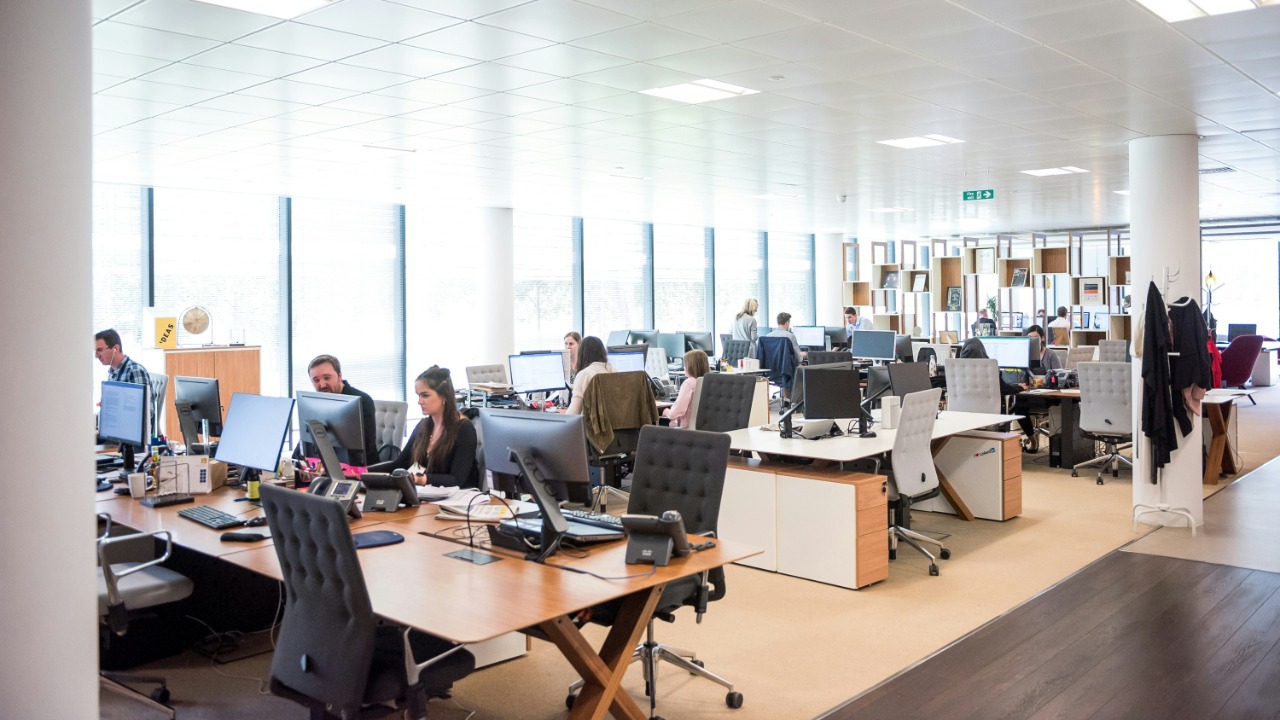 people working at desks in open office