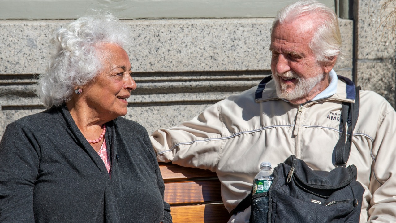 a man and a woman sitting on a bench