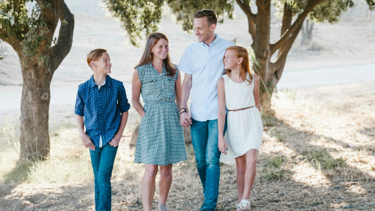 family standing in front of trees