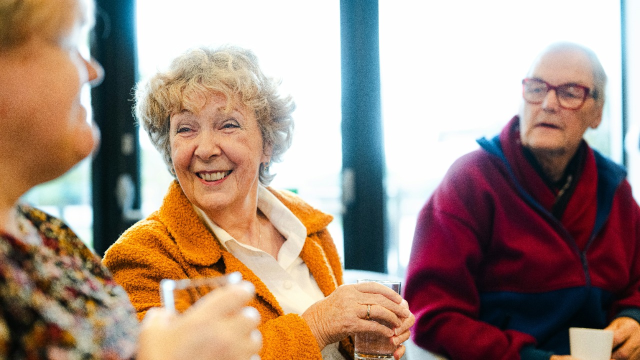 Three seniors talking and smiling together