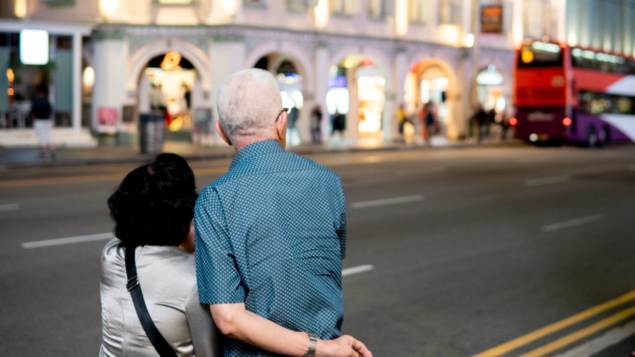 A man and a woman walking down a street