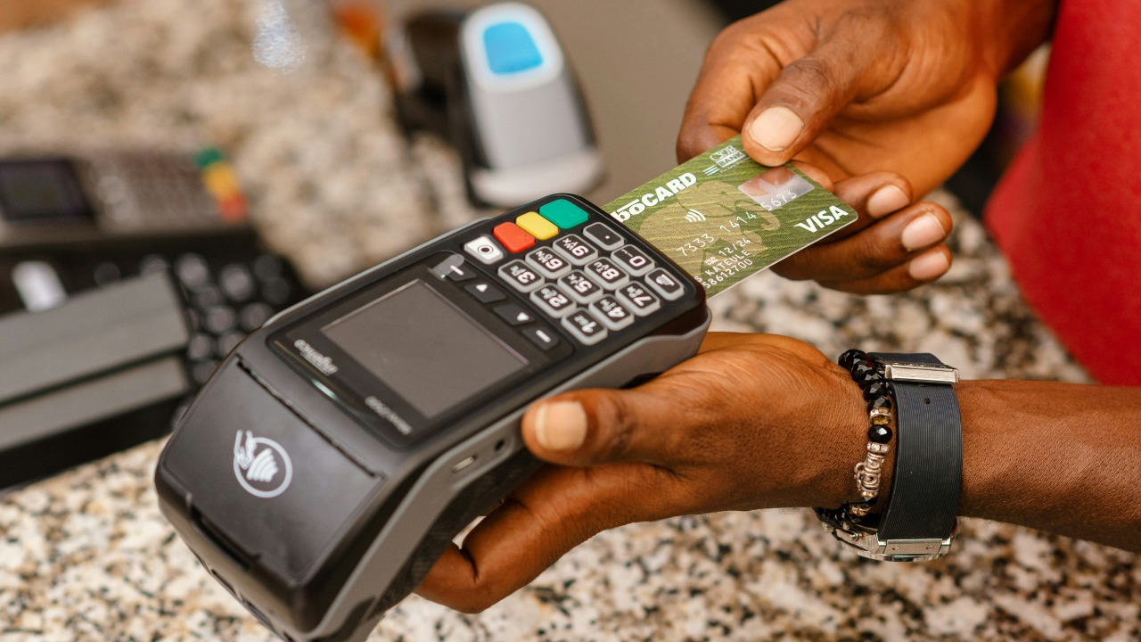 a person holding a credit card in their hand