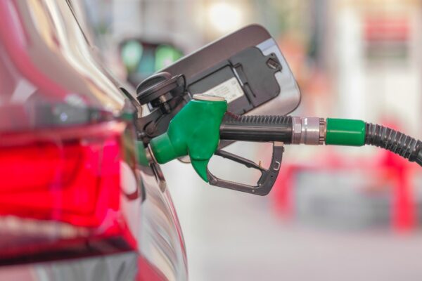 a gas pump is connected to a car at a gas station