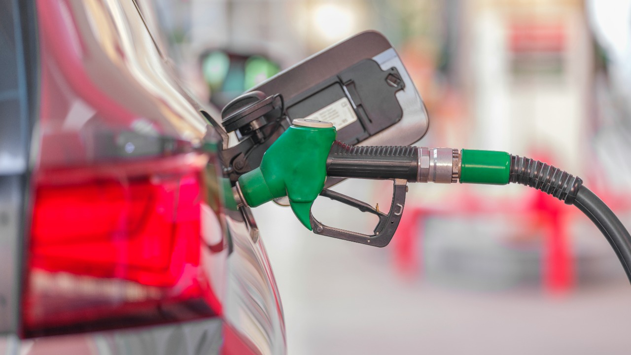 a gas pump is connected to a car at a gas station