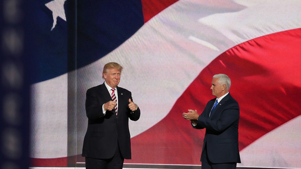 Donald Trump beside man in black suit