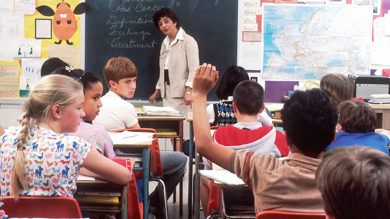 woman standing in front of children