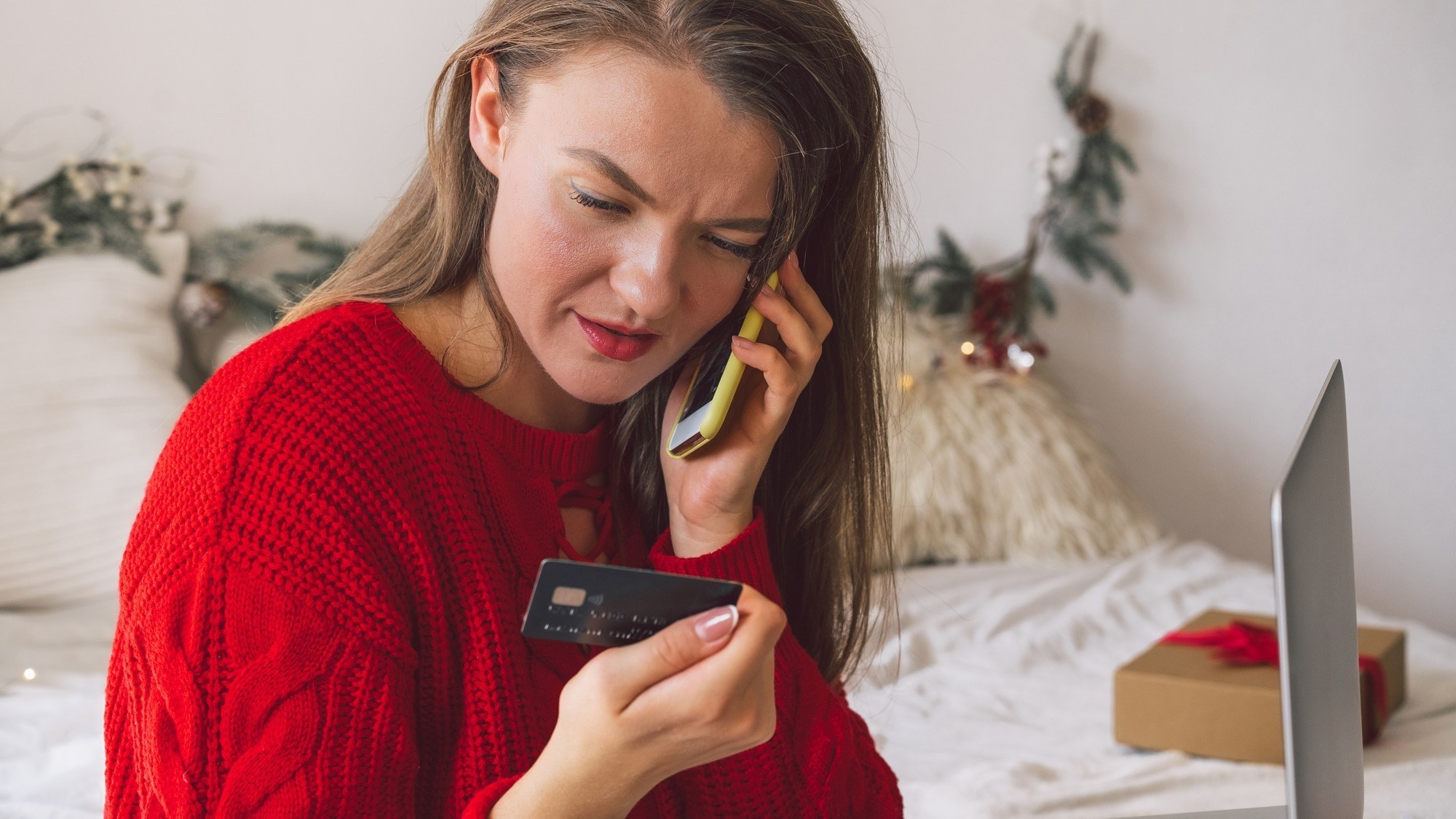 Image Credit: Young woman shopping online with credit card and mobile/