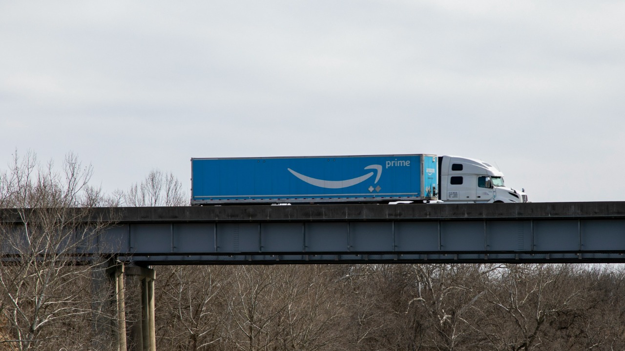 blue and white train on bridge during daytime