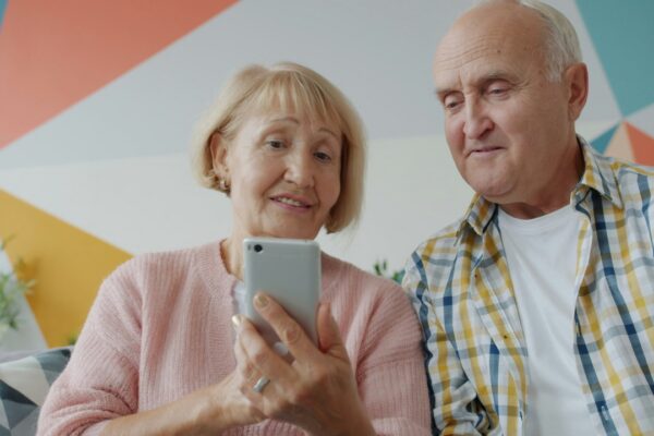 Elderly couple looking at a smartphone together on phone